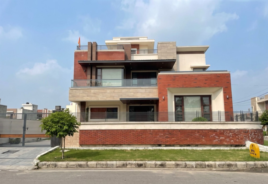 Contemporary residence in red brick and stone