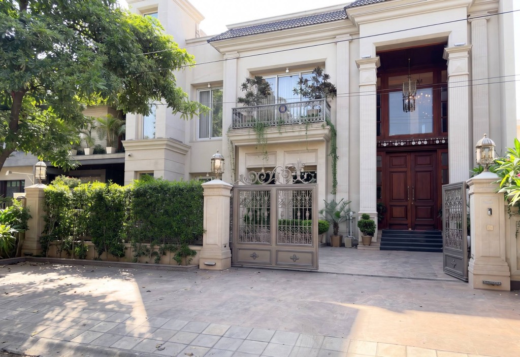 Classical villa with columned portico and ornamental gate